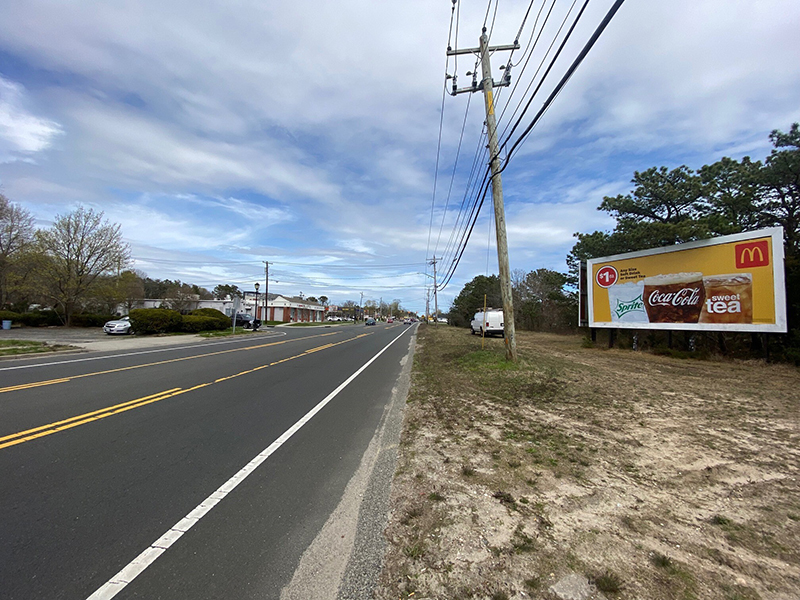 Bellport: south side of Route 27A, 30' west of Post Ave, facing west Media