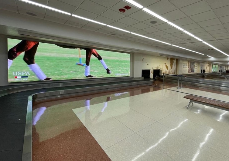 Package of 3 large LED Videowalls located on the back wall of baggage claim targeting arriving passenger with checked bags. Also easily viewable from rental car counters Media